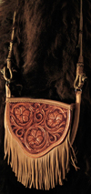 Cowgirl Cross-body Handbag by Keith Valley.  This bag is constructed with butter soft chap skin with overlaid tooling leather for the carved art.  Flowing Floral pattern on the face and a geometric stamp pattern on the back.  Handle Option either with leather strap hanger or hand braided rawhide horse bridle hanger for the shoulder strap.