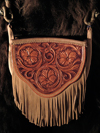 Cowgirl Cross-body Handbag by Keith Valley.  This bag is constructed with butter soft chap skin with overlaid tooling leather for the carved art.  Flowing Floral pattern on the face and a geometric stamp pattern on the back.  Handle Option either with leather strap hanger or hand braided rawhide horse bridle hanger for the shoulder strap.