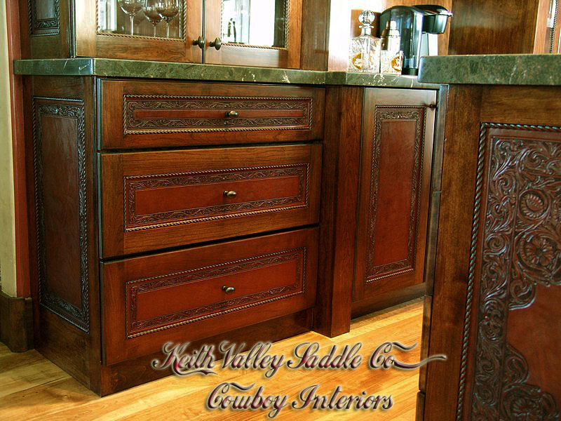 Every drawer and cabinet face designed with custom cowboy interior designs that are deeply hand carved, with greatest care, on the leather. Each piece has the eye appeal and a sense of living flow. All original cowboy art designs by Keith Valley